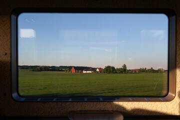 Daytime view from a van window of a typical farm with farmhouses nearby Helsingborg, Sweden