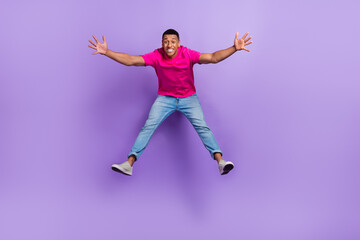 Fototapeta na wymiar Full size portrait of carefree cheerful person jumping falling isolated on purple color background