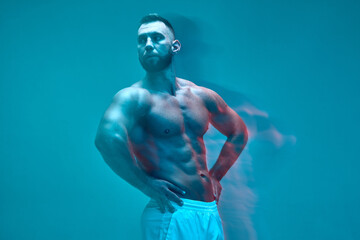 Athletic muscular man bodybuilder shows naked torso with strong abs muscles. Sports workout...
