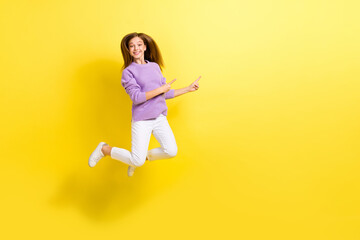 Fototapeta na wymiar Full length photo of positive overjoyed lady trendy violet sweater two arm direct empty space cool shop isolated on yellow color background