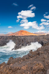 Powerful waves of the Atlantic Ocean crashing on the volcanic cliffs of Los Hervideros in Lanzarote,  Canary Islands, Spain