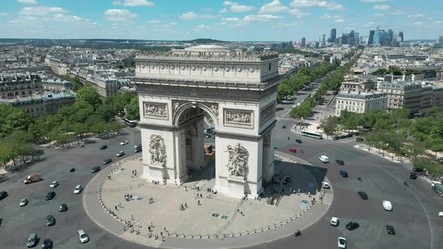 Drone flying around Triumphal arch with Paris cityscape, France. Aerial orbiting 