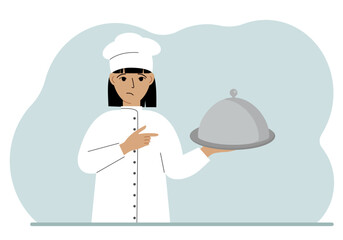 A female chef with a plate covered with a cloche or a tray with a lid.