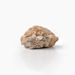 Raw aragonite crystal stone isolated on white background with reflection.