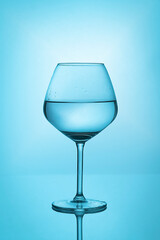 glass of water on blue background. closeup
