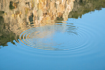 Circular waves in the water produced by the jump of a fish in the waters of the Tagus River in the area known as Salto del Gitano in Monfrague National Park