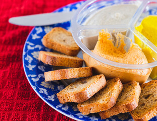 Slice of bread with fresh hummus dip