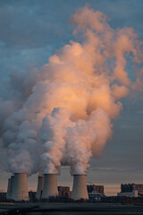 Smoking pipes of thermal power plant on sunset.