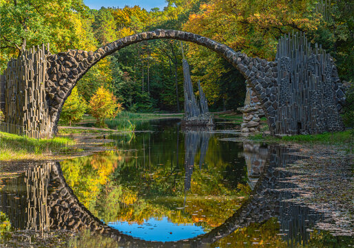 Arch Bridge in Kromlau, Saxony, Germany. Colorful autumn in Germany. Rakotz bridge in Kromlau