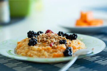 Cup of freshly brewed pumpkin porridge with berries. healthy food idea