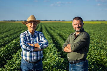 Portrait of two farmers in a soy field.