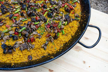 Vegetarian paella cooking over a fire at a food festival in Estoril, Lisbon.