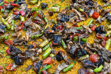 Vegetarian paella cooking over a fire at a food festival in Estoril, Lisbon.