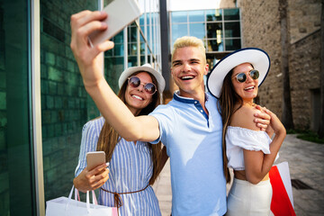 Group of young friends people doing selfie after shopping