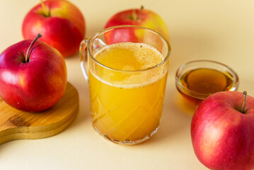 Fresh and Tasty Homemade Apple Cider with Ground Cinnamon Raw Red Apples Glass Mug with Cider on Wooden Stand Healthy Drink
