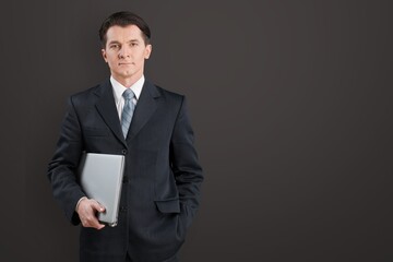 Young male business person hold a laptop
