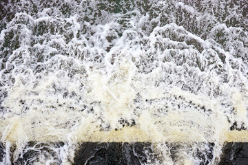 Foamed water top view with bubbles. Water foam waterfall threshold abstract background texture....