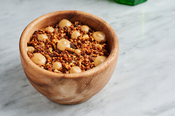 Fine dining plated main course dish of mashed potato, duck confit and apple caramel sauce on white marble background 