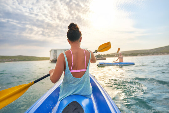 Couple Kayaking On Sunny Summer Lake