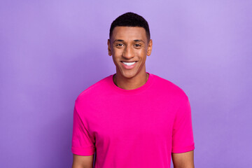 Portrait of handsome good mood satisfied man with fade haircut wear pink t-shirt dental advertise isolated on purple color background