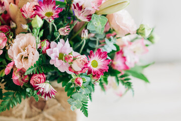 Beautiful pink flowers composition in the box close-up view. Festive decoration and background
