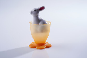 Fototapeta na wymiar toy rabbit in a plastic egg cup
