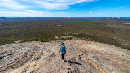 brave backpacker girl descends from frenchman peak in cape le grand national park in western...