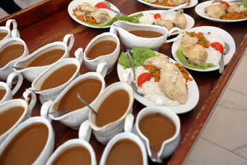 Sauce portions and boiled chicken meat with rice ready to serve, catering service