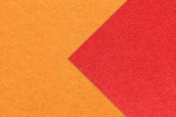 Texture of orange paper background, half two colors with red arrow, macro. Structure of craft ginger cardboard.