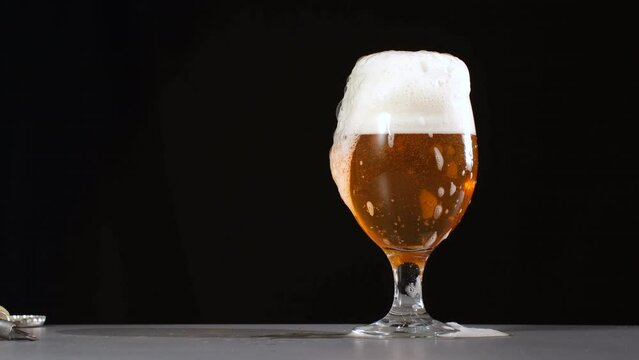 Beer Foam overflows out of glass