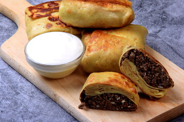 Traditional russian pancakes or blini with curd. Pancakes filled with minced heart or meat