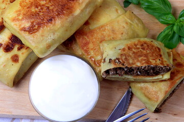 Traditional russian pancakes or blini with curd. Pancakes filled with minced heart or meat