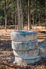 Walls of tires in the woods, paintball arena