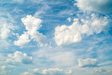 Fototapeta na wymiar Background with high blue sky and white clouds. Summer sky with cumulus clouds.