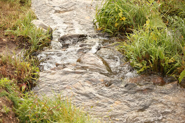 boulders in creek with water cascading over