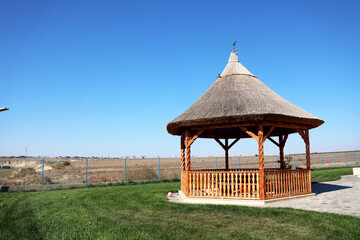 old fashioned rural traditional construction with reed house top blue painted made of wood or clay