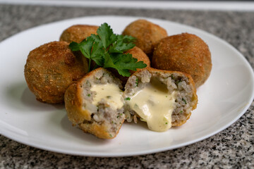 Close up of rice croquettes with melted cheese