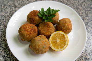 fried rice croquettes on a white plate