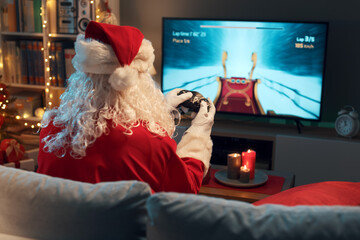 Funny Santa Claus playing video games at home © StockPhotoPro