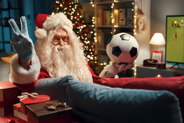 Happy Santa watching football on TV
