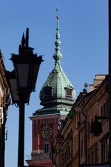 Vertical shot of the Lamp and copper roof tower in old town market square, Warsaw, Poland