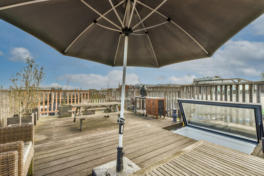 Terrace of a house with sofa and umbrella