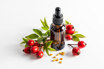 serum based on rosehip seed oil for facial skin care in a cosmetic bottle on a white background...