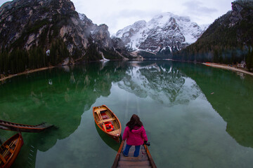 Braies Lake in Dolomites mountains Seekofel in background, Sudtirol, Italy. Lake Braies is also known as Lago di Braies. The lake is surrounded by the mountains which are reflected in the water.