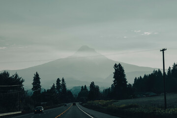 Fototapeta premium View from the Car with the road meeting Mt Hood covered in haze. 