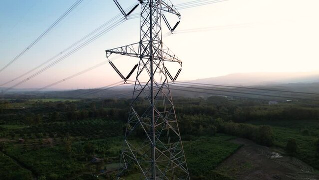 Silhouette of a high voltage pole structure. high voltage cable network in the rural forests. Energy concept