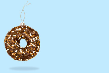 Christmas bauble ball decoration toy made of sweet sugar chocolate brown glazed doughnut donut...