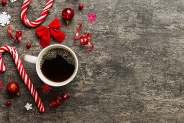 Delicious fresh festive morning coffee in a ceramic cup with little wrapped gifts, ornament and xmas toy. Cup of coffee and new year toys
