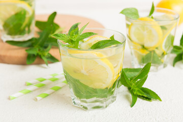 Mojito cocktail. Refreshing mojito cocktail with lime, lemon and mint in a tall glass with a stick