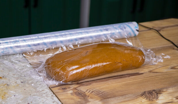 A view of the freshly cooked dough wrapped with cling film. Cooking delicious and flavorful desserts. The concept of working in the kitchen. Cooking. Selective focus